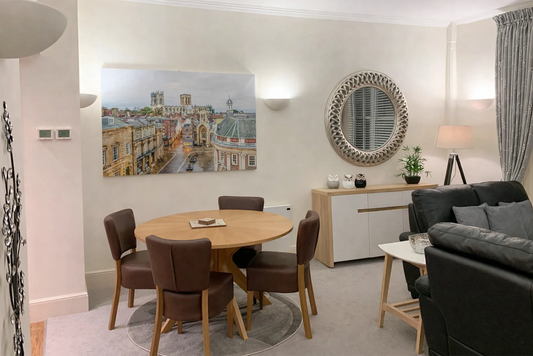 Hunter House Apartment dining area with round table and leather chairs in York city centre