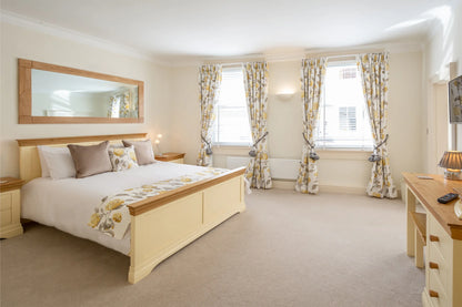 Hunter House Apartment bedroom 2 with king-size bed and twin windows in York city centre