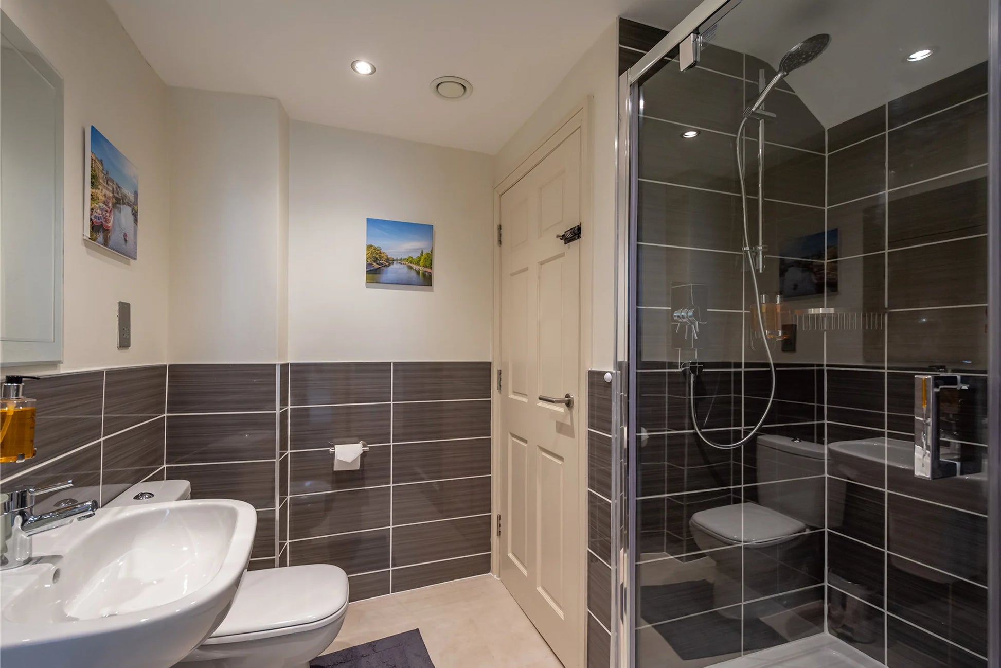 Hunter House Apartment bathroom with sink, toilet and shower area in York city centre