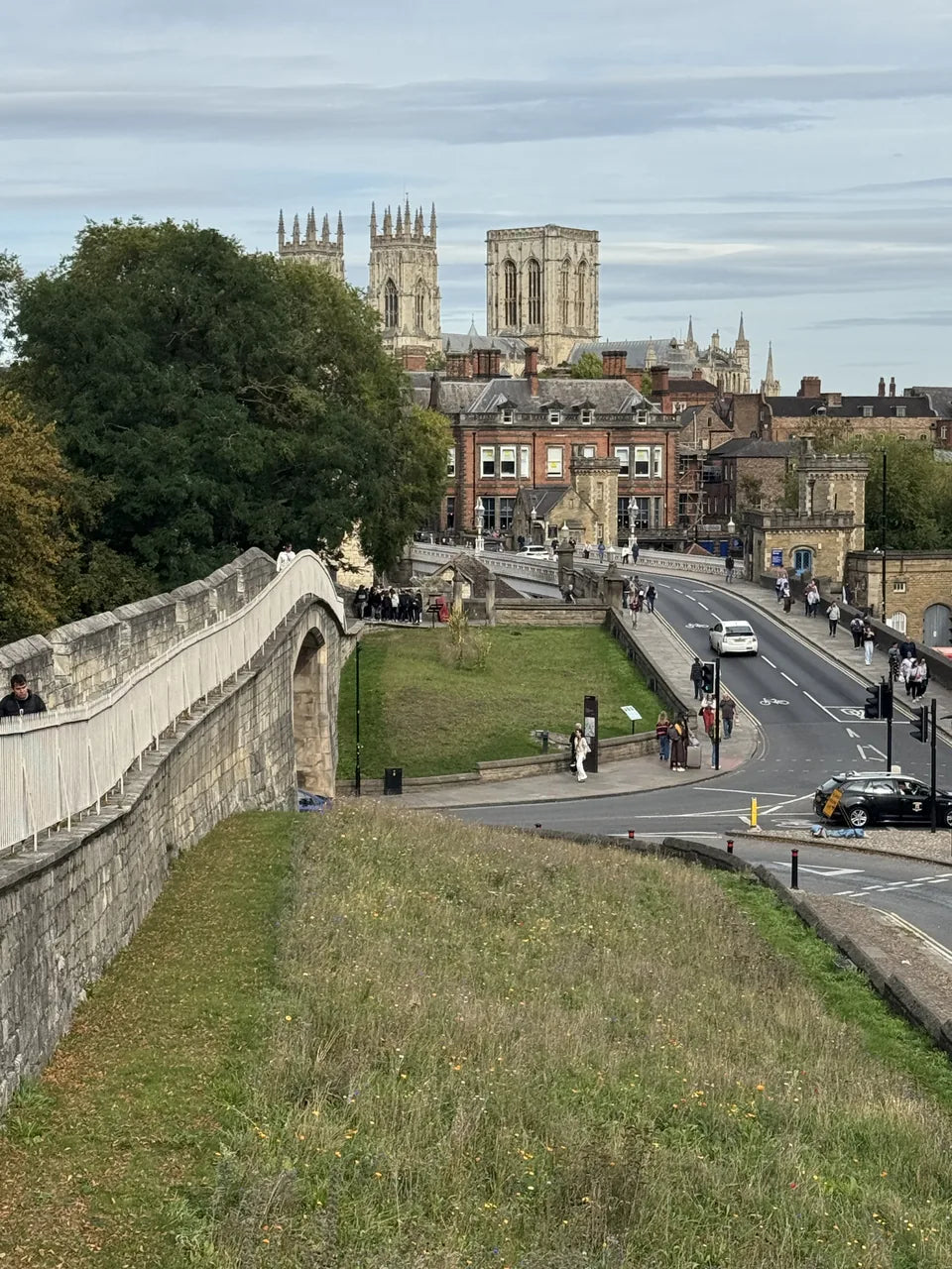 York’s city walls beside the road, with York Minster beyond the rooftops
