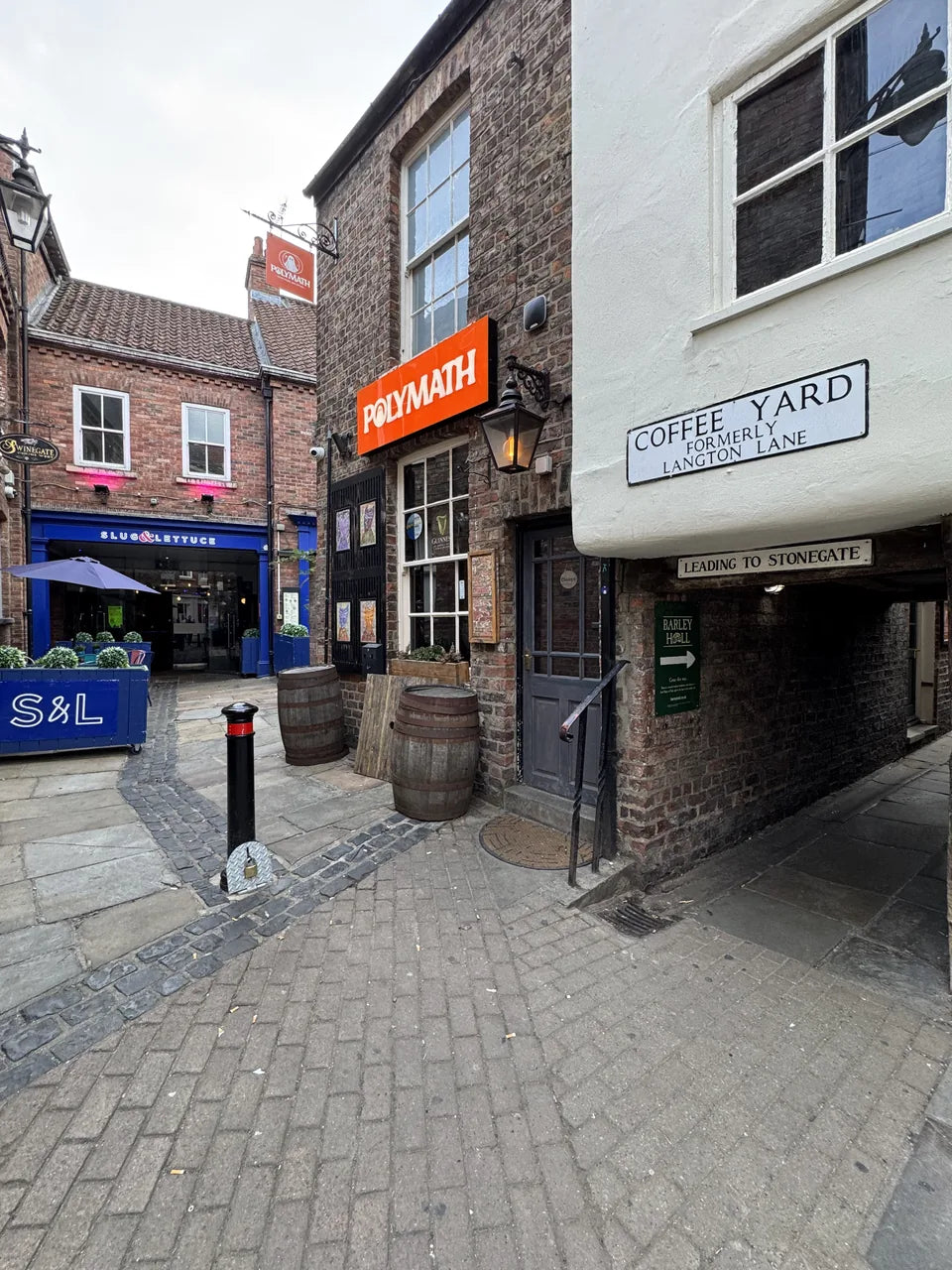 The Coffee Yard street sign at the entrance to a narrow passage off Stonegate