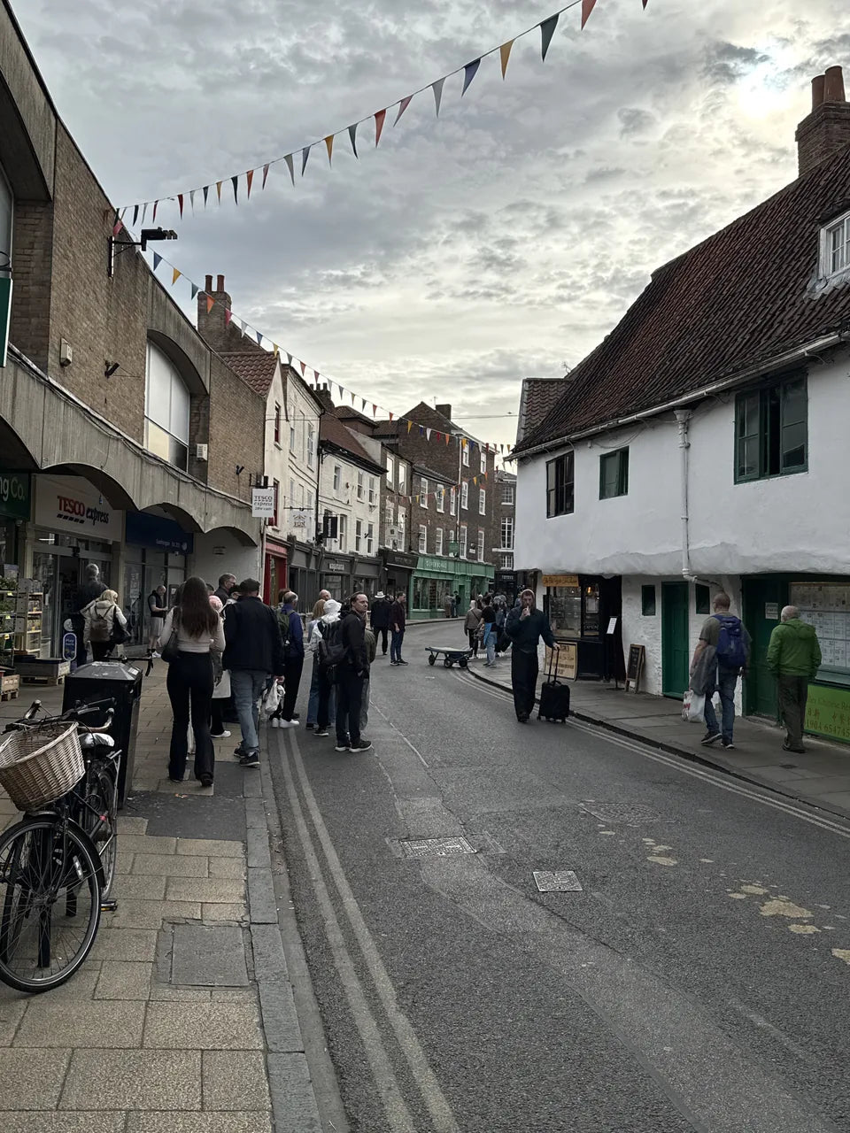 People gathering by the shops and timber-framed buildings around King’s Square