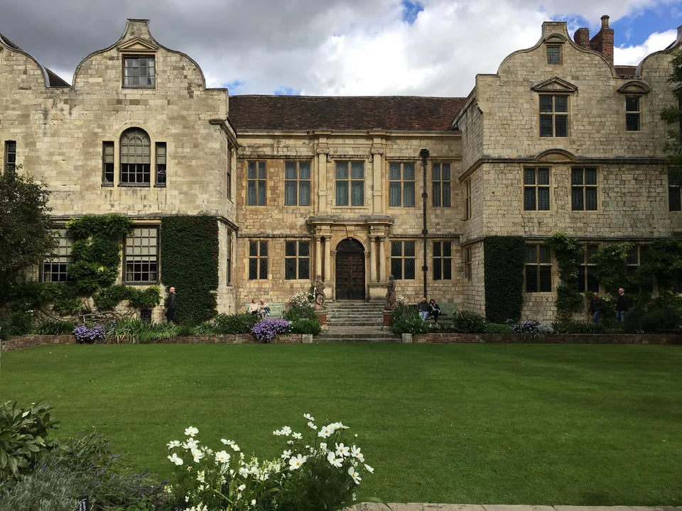 The stone façade of Treasurer’s House behind its formal garden and lawn in York